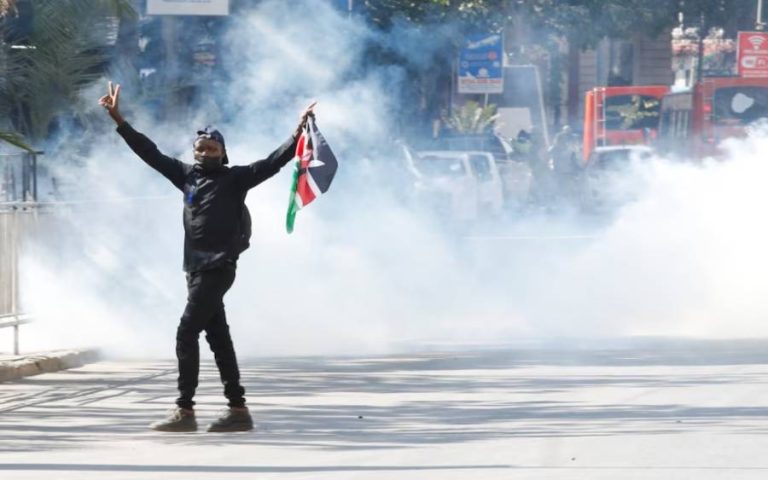 a-demonstrator-gestures-as-police-use-tear-gas-to-disperse-protesters-during-a-demonstration-against-kenya-proposed-finance-bill
