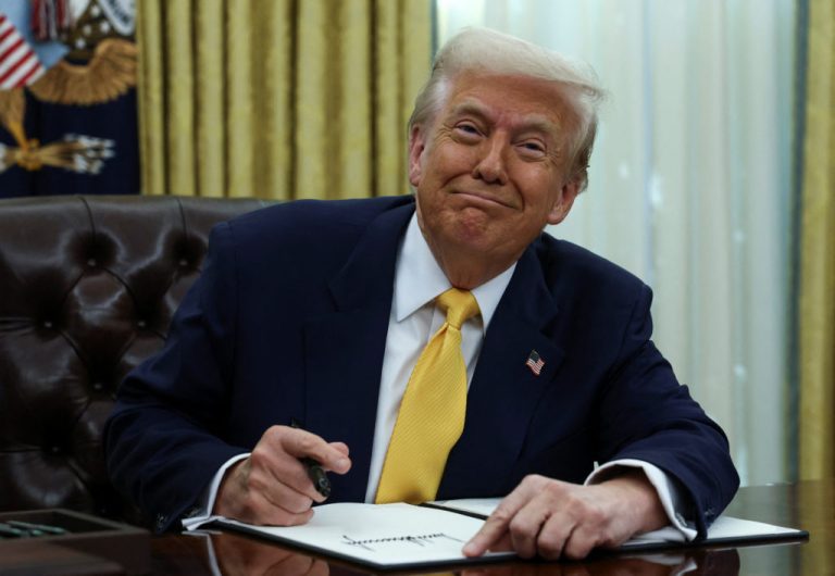 U.S. President Donald Trump signs an executive order in the Oval Office of the White House in Washington