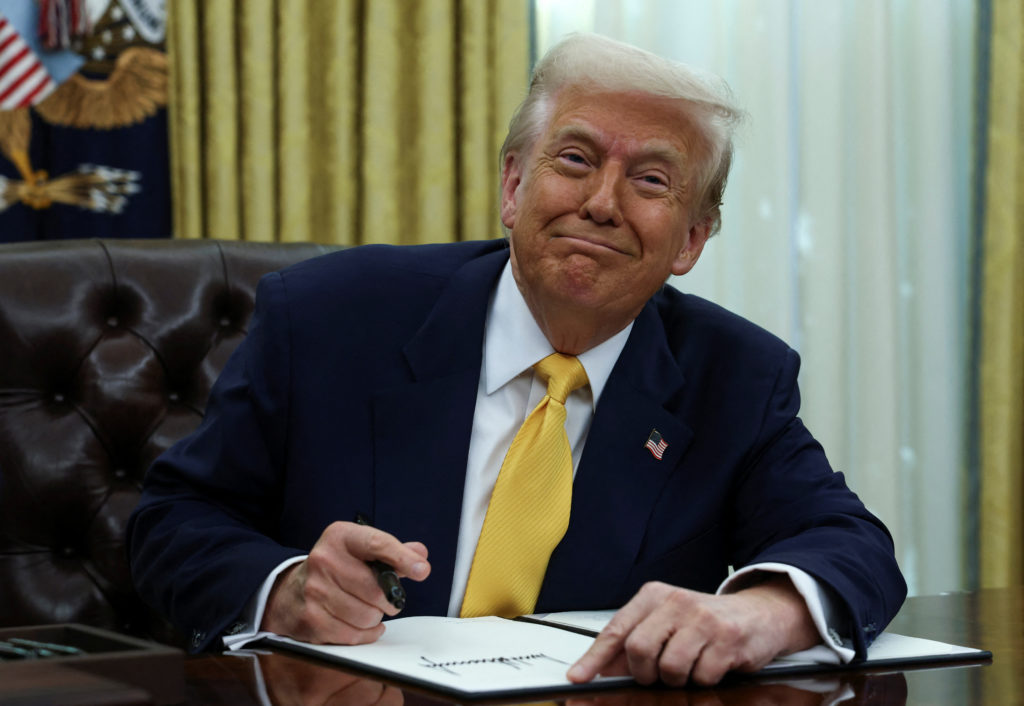 U.S. President Donald Trump signs an executive order in the Oval Office of the White House in Washington